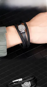 Detail view of multilayer braided leather bracelet with Viking compass metal charm