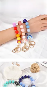 Detailed close-up of colorful silicone bead keychain bracelets with gold metal lobster clasps