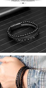 Close-up of men's braided leather bracelet with black beads and magnetic buckle