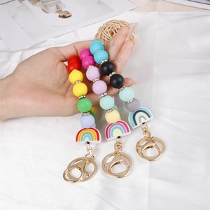 Rainbow silicone bead keychain wristlet with gold metallic ring and colorful charms