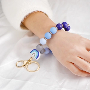 Chic silicone beaded keychain wristlet with blue rainbow charm and golden hardware
