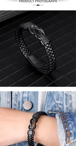 Detail of men's black braided leather bracelet featuring a sleek metal knot and clasp