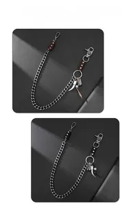 Detail of silver alloy pants chain with skull charm and leather strap accents