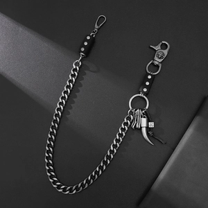Hip hop style silver curb chain trousers belt featuring ivory pendant and skull charm