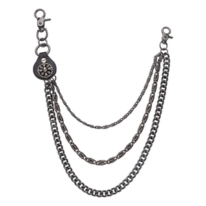 Detail of multi-layered punk biker chain with skull leather patch and weathered metal