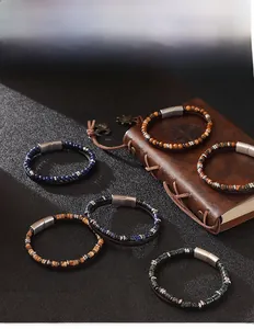 Macro detail of men's beaded bracelets with lapis lazuli and magnetic metal clasp