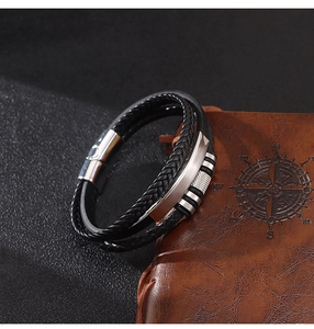 Detail of multi-layer braided leather bracelet with silver magnetic metal clasp