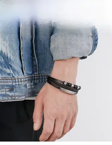 Detail of men's multilayer black braided leather bracelet with magnetic metal clasp