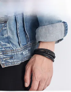 Close-up of a men's multilayer braided leather bracelet with a black magnetic clasp