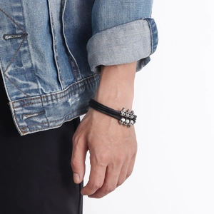 Men's punk multilayer black leather bracelet with silver skull metal studs on wrist