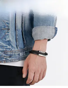 Close-up of men's layered leather bracelet with natural beads and magnetic clasp on wrist