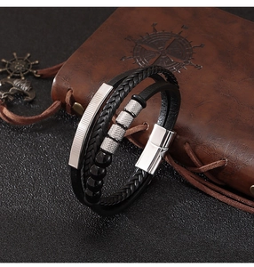 Detail of multi-layer leather bracelet with natural stone beads on a vintage book