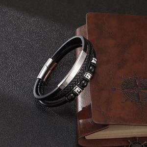 Men's multilayer PU leather beaded bracelet with silver magnetic clasp on vintage notebook