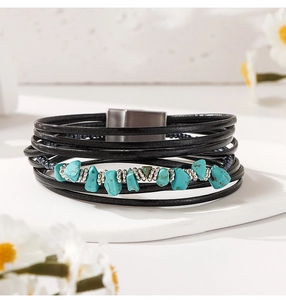 Close-up of bohemian leather wrap bracelet with natural turquoise stones and magnetic clasp