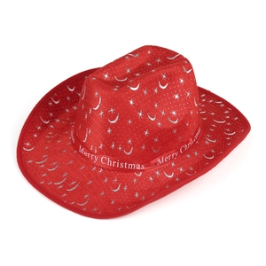 Close-up of red velvet cowboy hat with silver moon stars and Merry Christmas ribbon