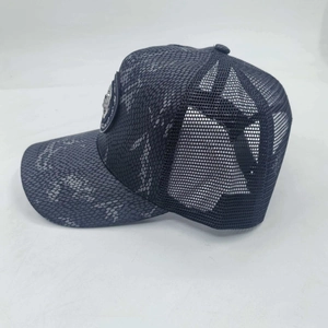 Black trucker cap with snakeskin pattern peak and metallic crest emblem detailing