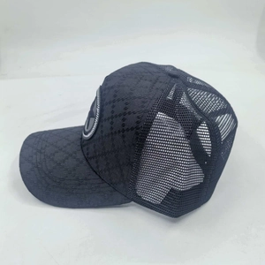 Detail of blue mesh baseball cap featuring diamond textured fabric and star patch design
