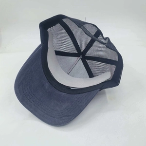 Detail view of navy blue mesh baseball cap showing breathable texture and adjustable strap