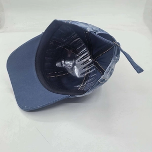 Detail view of denim baseball cap interior with sweatband and plastic support shell