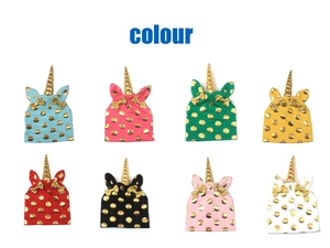 Detailed grid showing unicorn baby hats in eight colors with gold polka dots and spiral horn