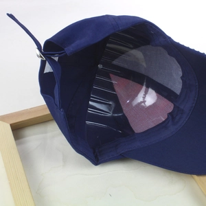 Inside view of navy blue baseball cap with internal support and silver metal buckle