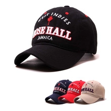 Detail view of cotton baseball caps with palm tree embroidery in black, navy, red, and beige