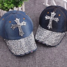 Detail of blue denim baseball caps with rhinestone cross and fully studded brims