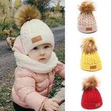 Detail showing knit baby beanie with pompom and matching neck warmer set in four colors