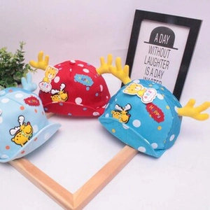 Dettaglio di cappellini colorati per bambini con corna gialle e ricamo a orsetto