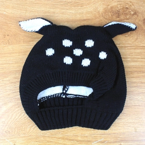 Detail of baby winter deer hat with black knit, white polka dots, and small ears