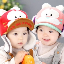 Close-up of winter baby hat with cute cartoon cat ears and warm ear protection flaps