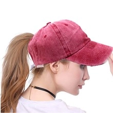 Detail of burgundy washed denim ponytail baseball cap showing the functional back opening