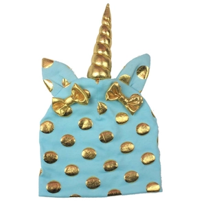 Detail of baby unicorn knit hat in sky blue with golden dots and decorative bows