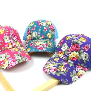 Detailed view of floral mesh baseball caps in rose red, blue and purple colors