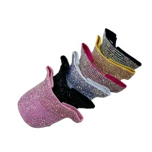 Collection of sparkly rhinestone baseball caps in pink, black, blue, and yellow shades