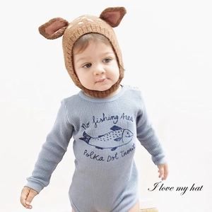 Detail of baby deer knit hat with 3D ears and blue waffle romper with fish print