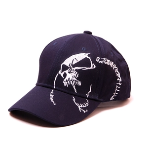 Close-up of white skull and spine embroidery on a navy blue cotton baseball cap