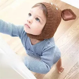 Close-up of knit deer baby hat in coffee brown with white spotted reindeer ear details