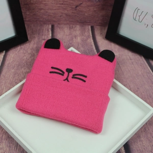 Cute rose pink knit beanie for kids featuring black cat ears and embroidered cat face design