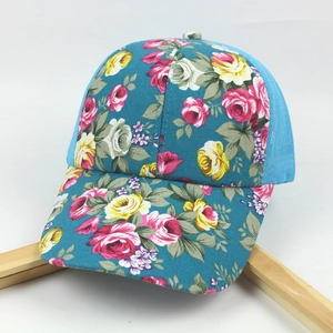 Detailed close-up of a floral print mesh baseball cap with blue rose canvas patterns