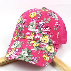 Detailed side view of floral mesh baseball cap with pink base and rose flower patterns