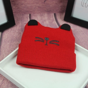 Cute red knit baby beanie with black cat ears and embroidered kitten face detail