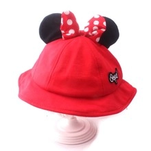 Detail of red Minnie-style kids bucket hat with black ears and polka dot bow