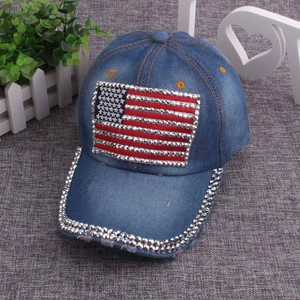 Detail of American flag rhinestone pattern on blue washed denim baseball cap