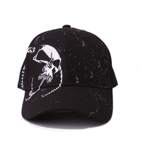 Black cotton baseball cap featuring a white skull embroidery and vintage ink splatter design