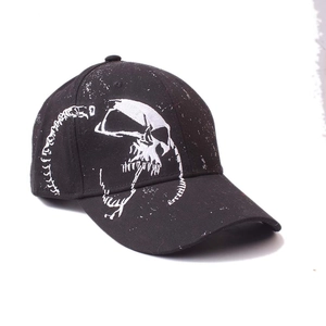 Macro shot of skull embroidery and artistic lettering on a black cotton baseball cap