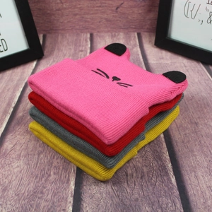 Detailed macro view showing four colored knit hats with cat ears and nose embroidery