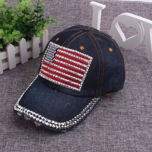 Close-up of denim baseball cap with rhinestone US flag and silver crystal brim details