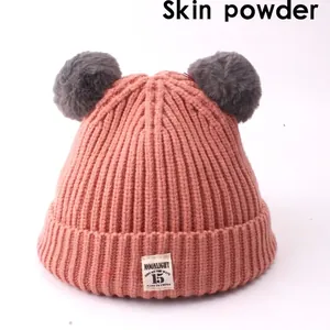 Pink knit baby beanie with grey faux fur pom-poms and Moonlight label for autumn winter