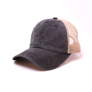 Detail of vintage washed grey cotton fabric and breathable beige mesh on trucker cap